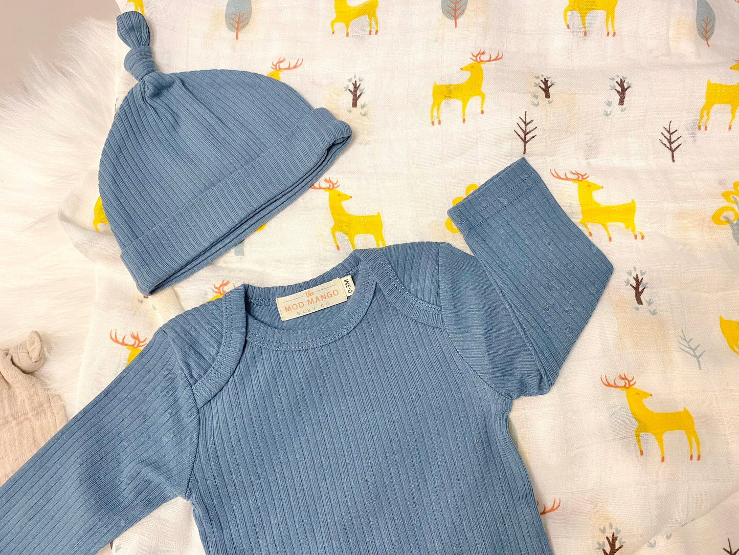 blue deer baby boy gift, newborn boy gift set, gift baby boy, deer swaddle blanket, ribbed knit long sleeve bodysuit with knot hat, muslin swaddle organic cotton gift set baby boy, lion lovey comforter blanket, blue deer hunting baby boy