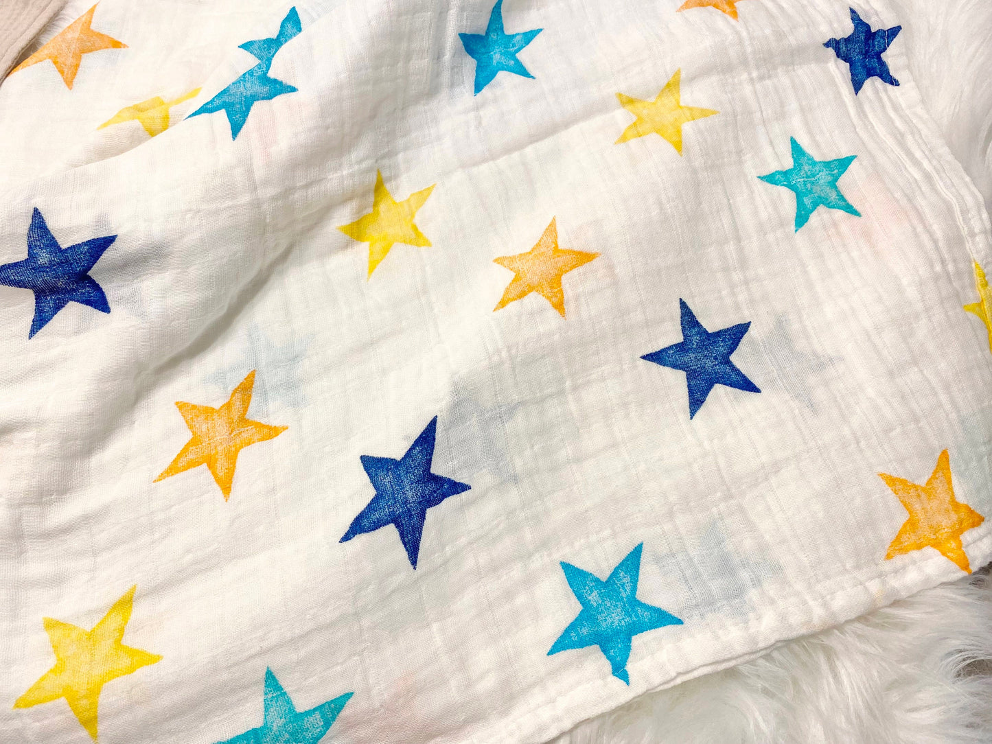 colorful stars baby boy gift, newborn boy gift set, gift baby boy, swaddle blanket, blue ribbed knit long sleeve bodysuit with knot hat, muslin swaddle organic cotton gift set baby boy, lion lovey comforter blanket, yellow turquoise baby gift