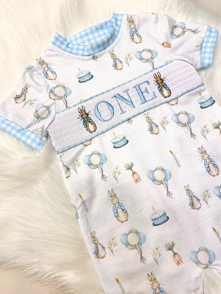 peter rabbit shirt first birthday boy romper spring baby blue and white gingham checkered tan beige outfit, ONE smocked bubble romper first birthday bunny rabbit, some bunny is one embroidered smocked 1st birthday outfit romper baby boys easter, the mod mango baby boutique co