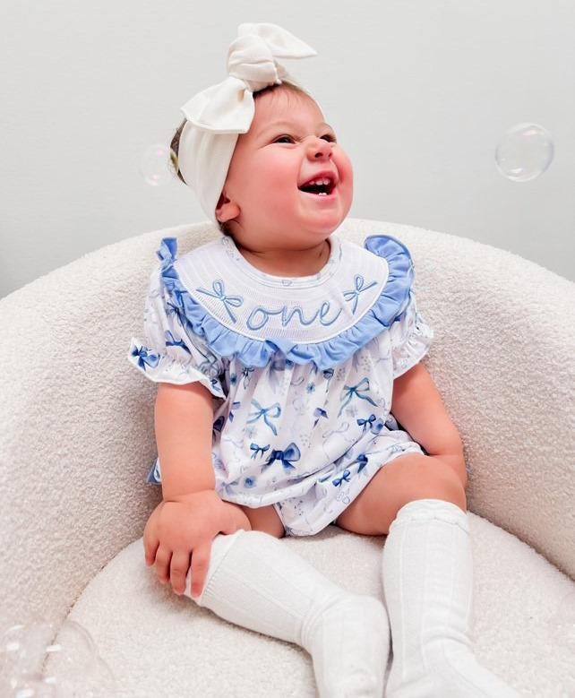 blue bow first birthday girl romper blue and white outfit, love shack fancy one bubble girls just want to be one smocked bubble romper first birthday spring bows ruffle bows embroidered smocked short sleeve 1st birthday outfit romper baby girls