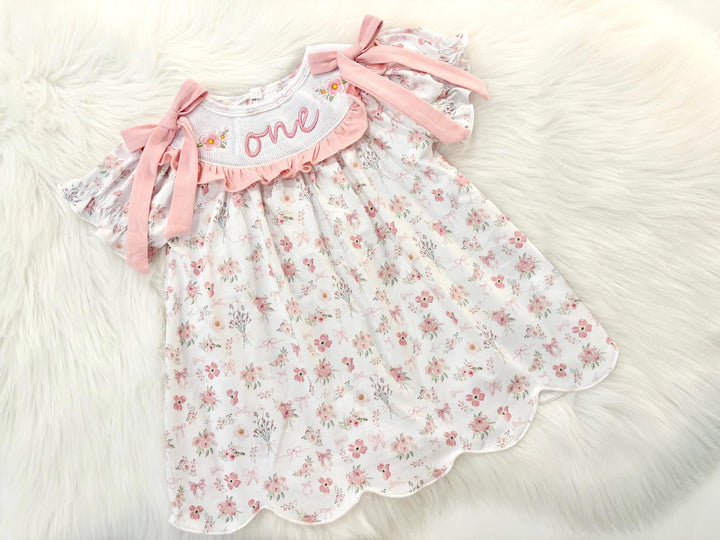 wild one wildflower ONEderful girls first birthday dress outfit blush pink flowers and bows first birthday girl dress pink and white outfit, one little candle, dusty rose blush pink green floral smocked dress first birthday embroidered flowers smocked short sleeve 1st birthday outfit ruffle scalloped dress, the mod mango baby boutique co