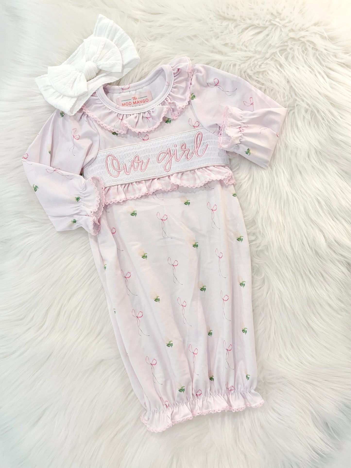 newborn girls pink and white baby gown with flowers for baby girl, our girl monogram baby shower gift for girl, light pink gingham baby gift, newborn coming home outfit, baby shower gift set, pregnancy announcement, custom newborn baby gown, boutique smocked baby gift set, the mod mango baby boutique co