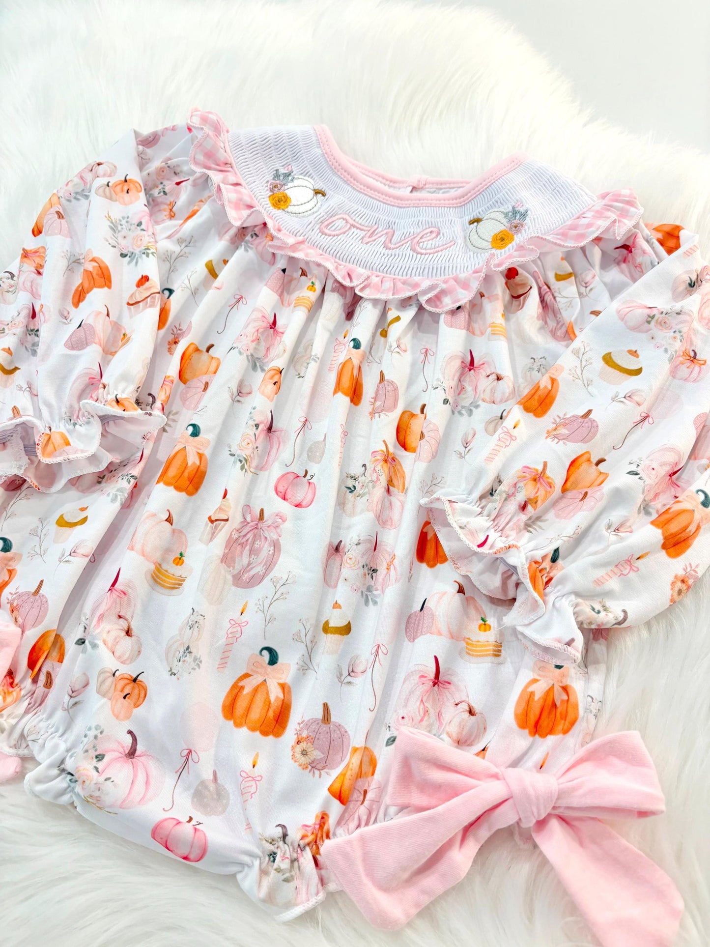 pink pumpkin bow first birthday girl romper blush pink orange floral and white outfit, pink and white gingham smocked bubble romper first birthday fall pumpkins ruffle bows embroidered smocked long sleeve 1st birthday outfit romper baby girls, the mod mango, the mod mango baby co baby boutique