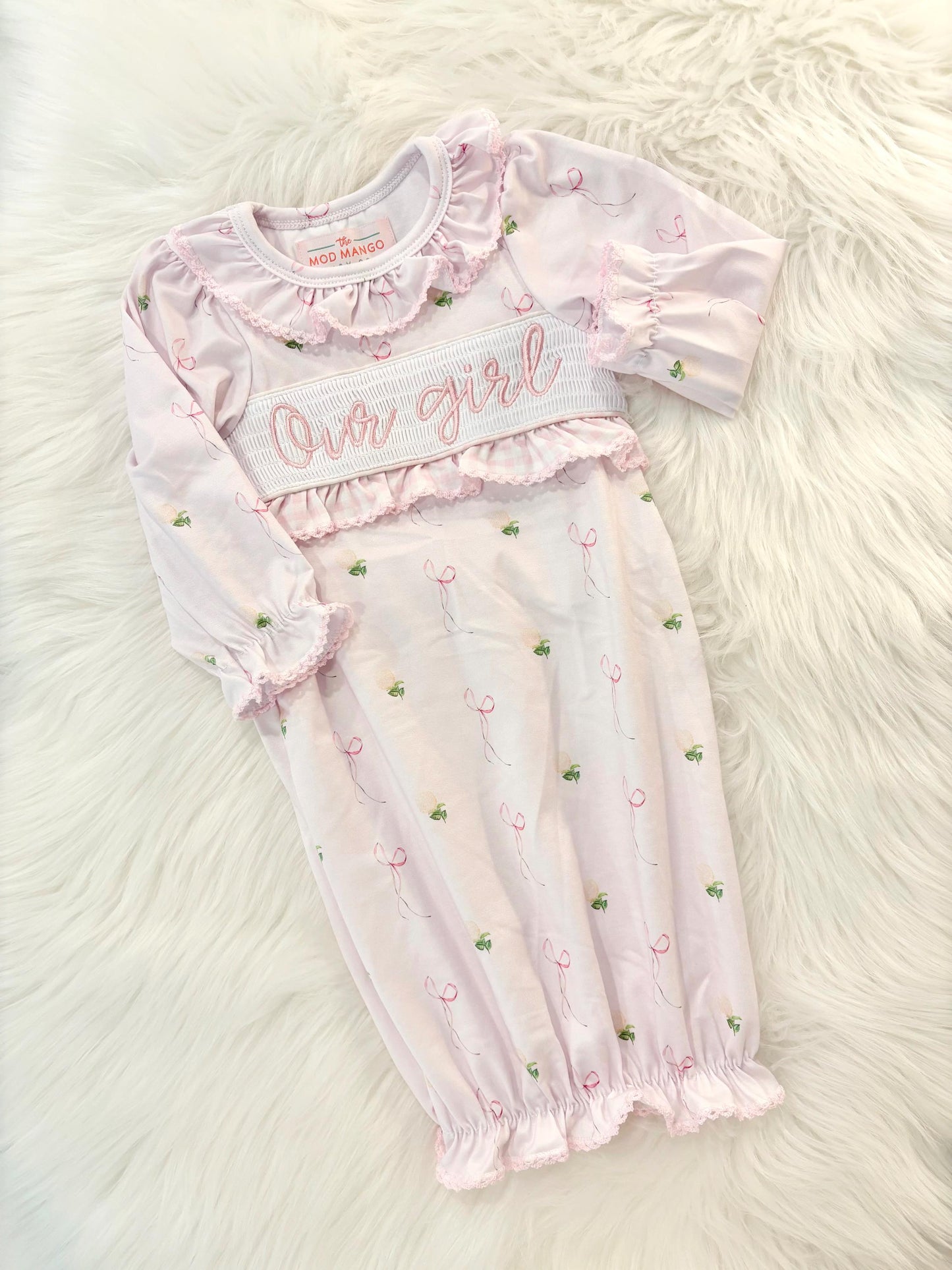 newborn girls pink and white baby gown with flowers for baby girl, our girl monogram baby shower gift for girl, light pink gingham baby gift, newborn coming home outfit, baby shower gift set, pregnancy announcement, custom newborn baby gown, boutique smocked baby gift set, the mod mango baby boutique co