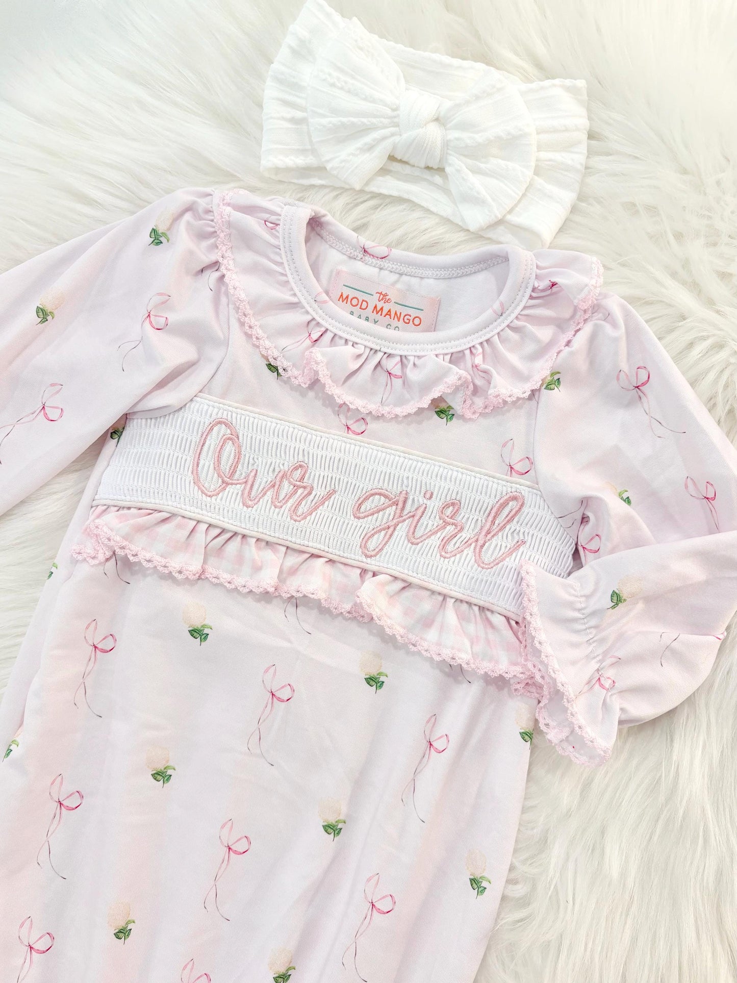 newborn girls pink and white baby gown with flowers for baby girl, our girl monogram baby shower gift for girl, light pink gingham baby gift, newborn coming home outfit, baby shower gift set, pregnancy announcement, custom newborn baby gown, boutique smocked baby gift set, the mod mango baby boutique co