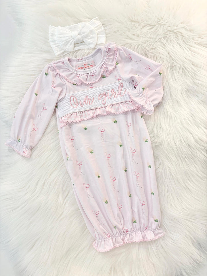 newborn girls pink and white baby gown with flowers and bows coquette for baby girl, our girl monogram baby shower gift for girl, light pink gingham baby gift, newborn coming home outfit, baby shower gift set, pregnancy announcement, custom newborn baby gown, boutique smocked baby gift set, the mod mango baby boutique co