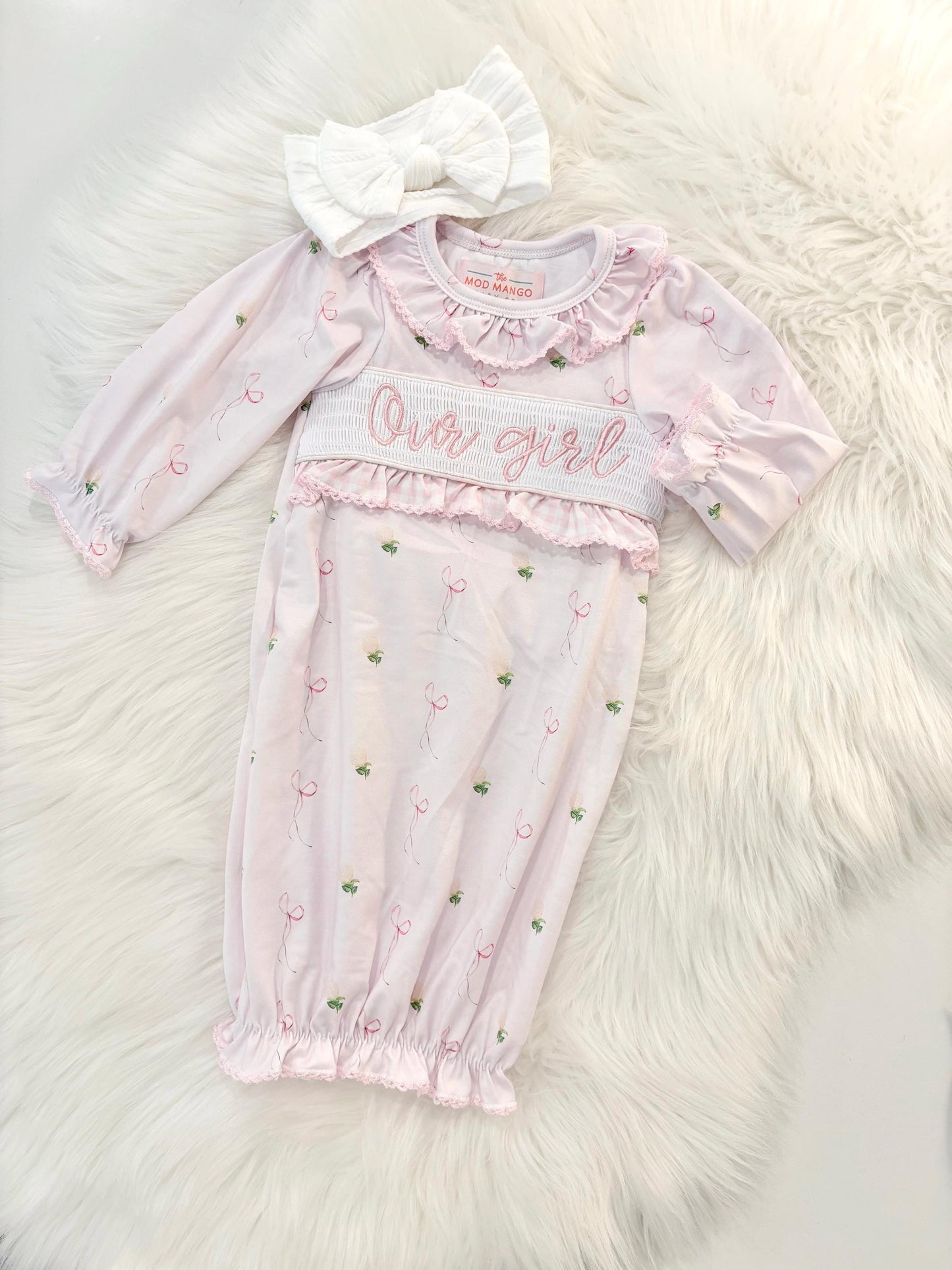 newborn girls pink and white baby gown with flowers for baby girl, our girl monogram baby shower gift for girl, light pink gingham baby gift, newborn coming home outfit, baby shower gift set, pregnancy announcement, custom newborn baby gown, boutique smocked baby gift set, the mod mango baby boutique co
