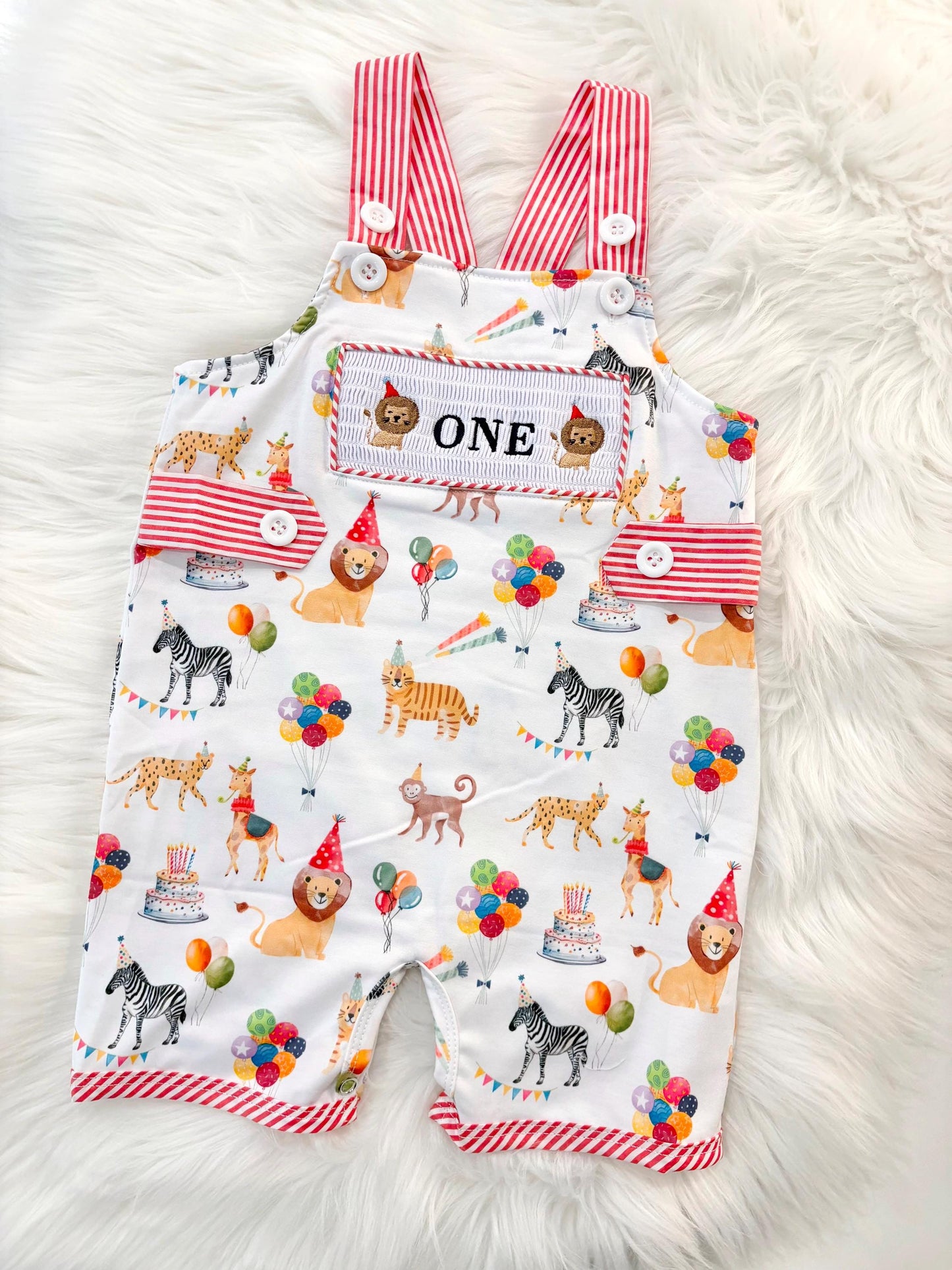 carnival circus party animal cake smash outfit first birthday boy romper 1st birthday red and white striped stripes colorful smash cake outfit overalls, ONE smocked romper first birthday, animals lion embroidered smocked spring summer 1st birthday boy outfit romper baby boys cake smash outfit, the mod mango baby boutique co