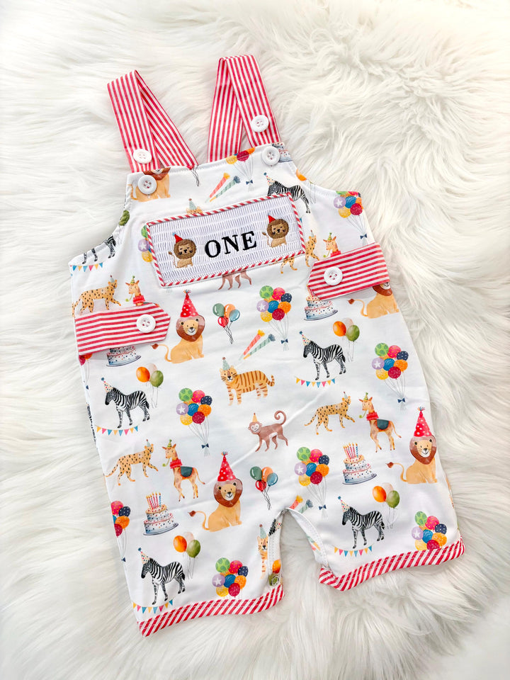 carnival circus party animal cake smash outfit first birthday boy romper 1st birthday red and white striped stripes colorful smash cake outfit overalls, ONE smocked romper first birthday, animals lion embroidered smocked spring summer 1st birthday boy outfit romper baby boys cake smash outfit, the mod mango baby boutique co