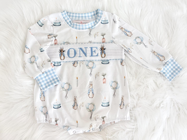 peter rabbit shirt first birthday boy romper spring baby blue and white gingham checkered tan beige outfit, ONE smocked bubble romper first birthday bunny rabbit, some bunny is one embroidered smocked 1st birthday outfit romper baby boys easter, the mod mango baby boutique co