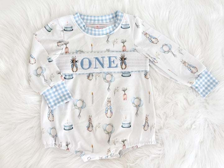 peter rabbit shirt first birthday boy romper spring baby blue and white gingham checkered tan beige outfit, ONE smocked bubble romper first birthday bunny rabbit, some bunny is one embroidered smocked 1st birthday outfit romper baby boys easter, the mod mango baby boutique co