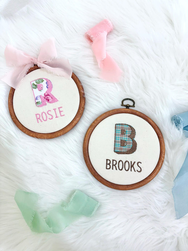 Custom Name Embroidery Hoop, Newborn Baby's First Name Initial Embroidered Hoop Ornament Keepsake Milestone baby name hoop, new baby embroidery customized unique baby name sign for hospital embroidered round hoop, floral plaid pattern linen red blue pink beige neutral green gold, wooden embroidery hoop baby room decor, first milestone keepsake, newborn baby gift customized with name, the mod mango baby co