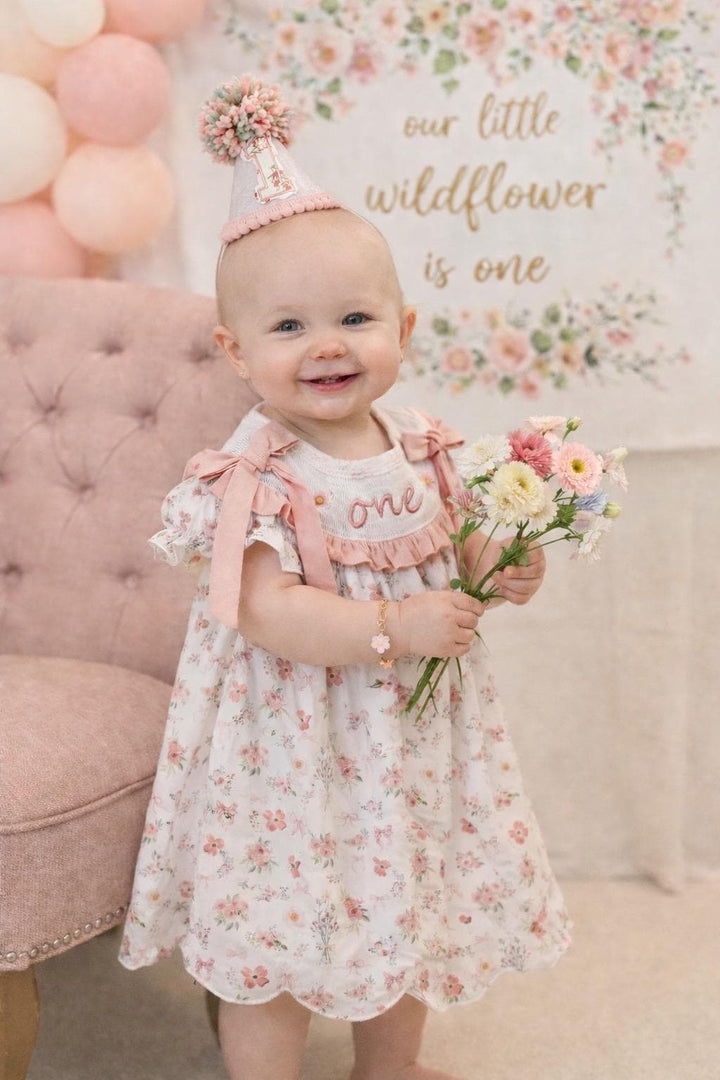 wild one wildflower ONEderful girls first birthday dress outfit blush pink flowers and bows first birthday girl dress pink and white outfit, one little candle, dusty rose blush pink green floral smocked dress first birthday embroidered flowers smocked short sleeve 1st birthday outfit ruffle scalloped dress, the mod mango baby boutique co
