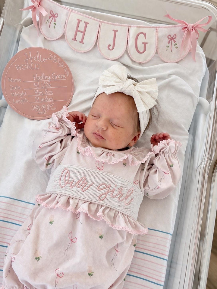 newborn girls pink and white baby gown with flowers and bows coquette for baby girl, our girl monogram baby shower gift for girl, light pink gingham baby gift, newborn coming home outfit, baby shower gift set, pregnancy announcement, custom newborn baby gown, boutique smocked baby gift set, the mod mango baby boutique co