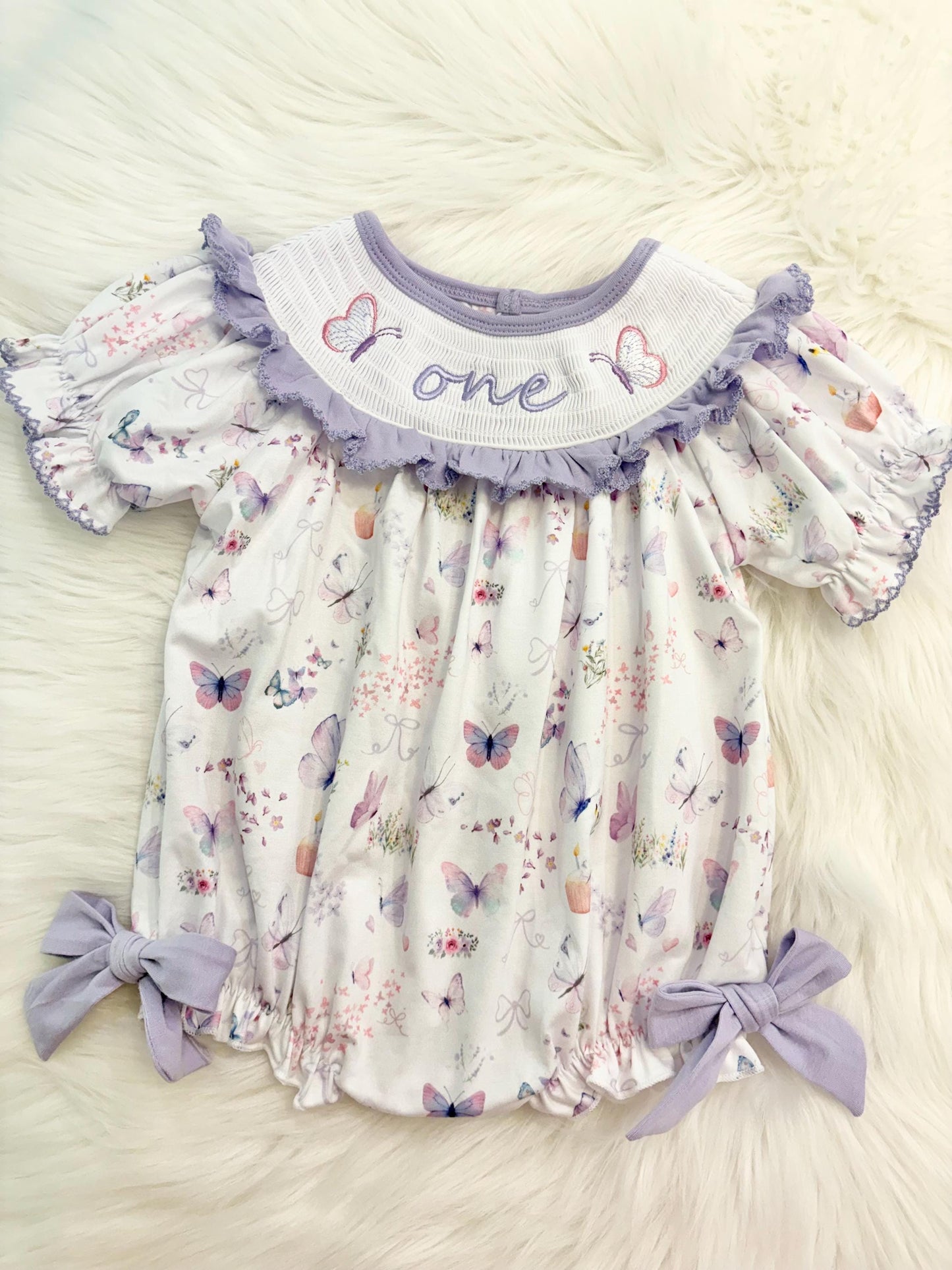 lavender purple butterfly flowers bows first birthday girl romper pink pastel floral and white outfit, pink lavender and white smocked bubble romper butterflies first birthday one year fluttered by ruffle bows embroidered smocked 1st birthday outfit romper baby girls, the mod mango, the mod mango baby co baby boutique