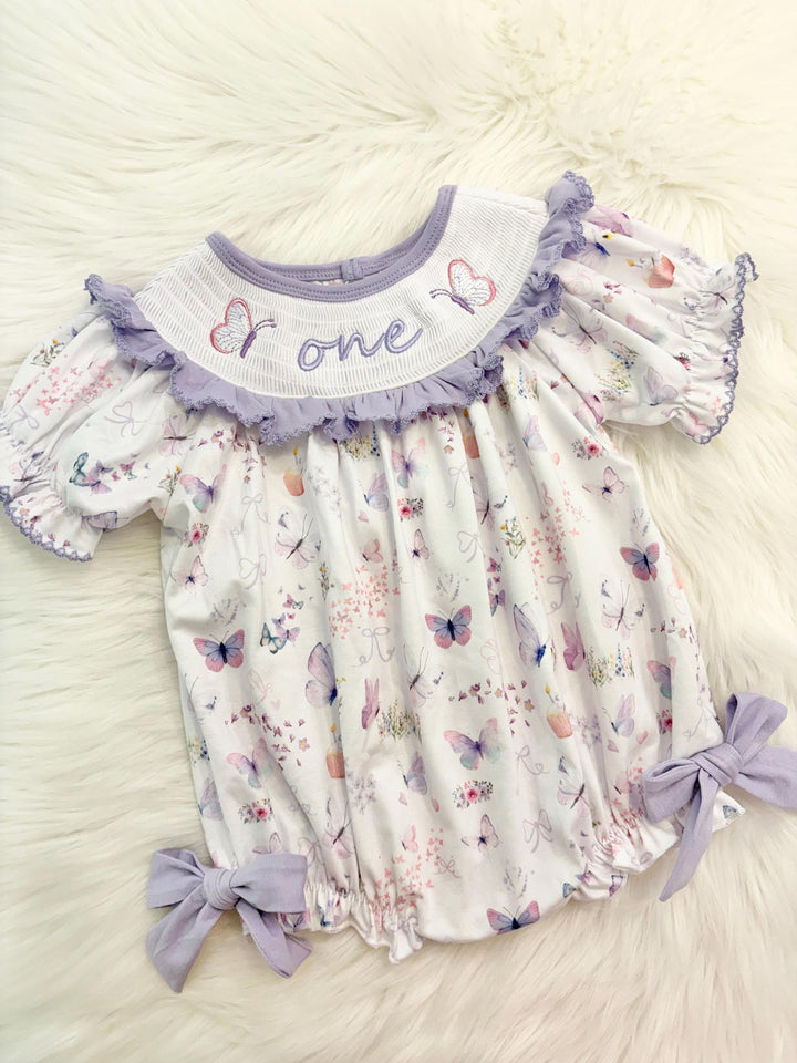 lavender purple butterfly flowers bows first birthday girl romper pink pastel floral and white outfit, pink lavender and white smocked bubble romper butterflies first birthday one year fluttered by ruffle bows embroidered smocked 1st birthday outfit romper baby girls, the mod mango, the mod mango baby co baby boutique