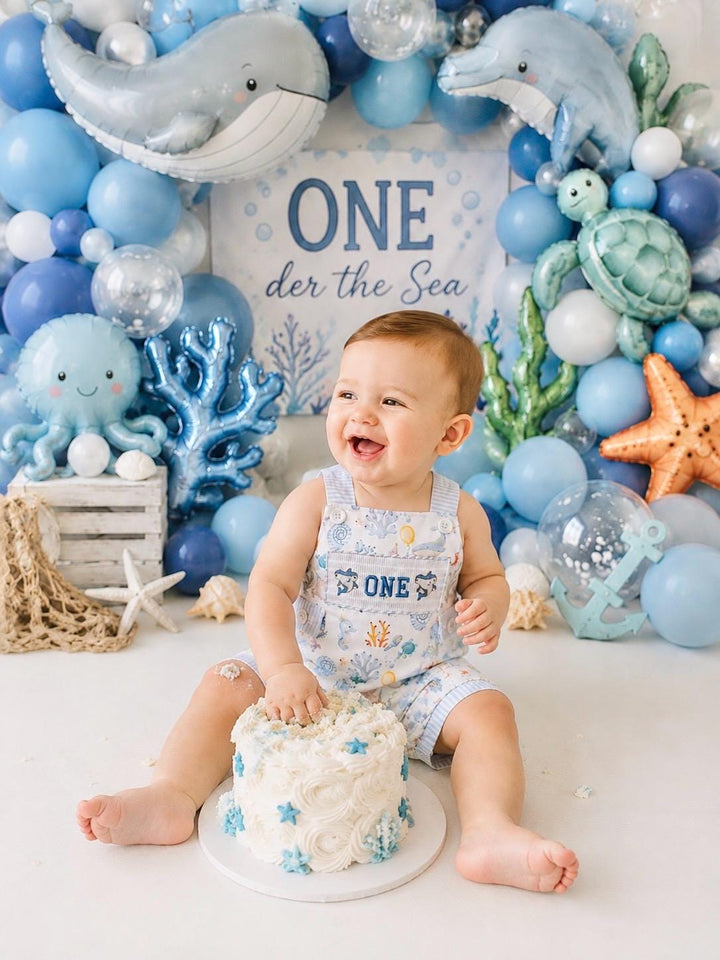 oneder the sea cake smash outfit first birthday boy romper under the sea ocean summer baby blue green white orange blue smash cake outfit overalls, ONE smocked romper first birthday sea ocean creatures party fish, beach ocean shark whale seashells octopus outdoors embroidered smocked spring summer 1st birthday boy outfit romper baby boys cake smash outfit, the mod mango baby boutique co