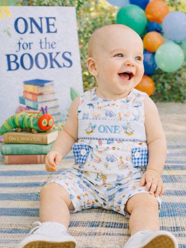 chapter one books birthday boy romper one for the books shortalls blue white gingham smash cake outfit overalls, ONE smocked romper first birthday books, storybooks baby goose embroidered smocked spring summer fall 1st birthday boy outfit romper baby boys reading 1st birthday, the mod mango baby co