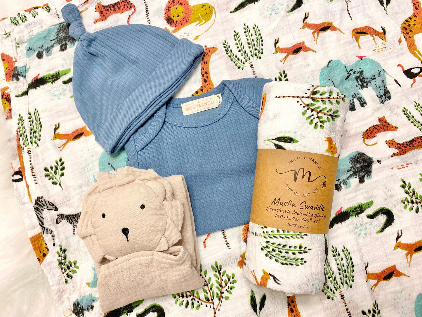 baby boy gift, newborn boy gift set, gift baby boy, jungle safari swaddle blanket, blue ribbed knit long sleeve bodysuit with knot hat, muslin swaddle organic cotton gift set baby boy, lion lovey comforter blanket, baby shower gift set box