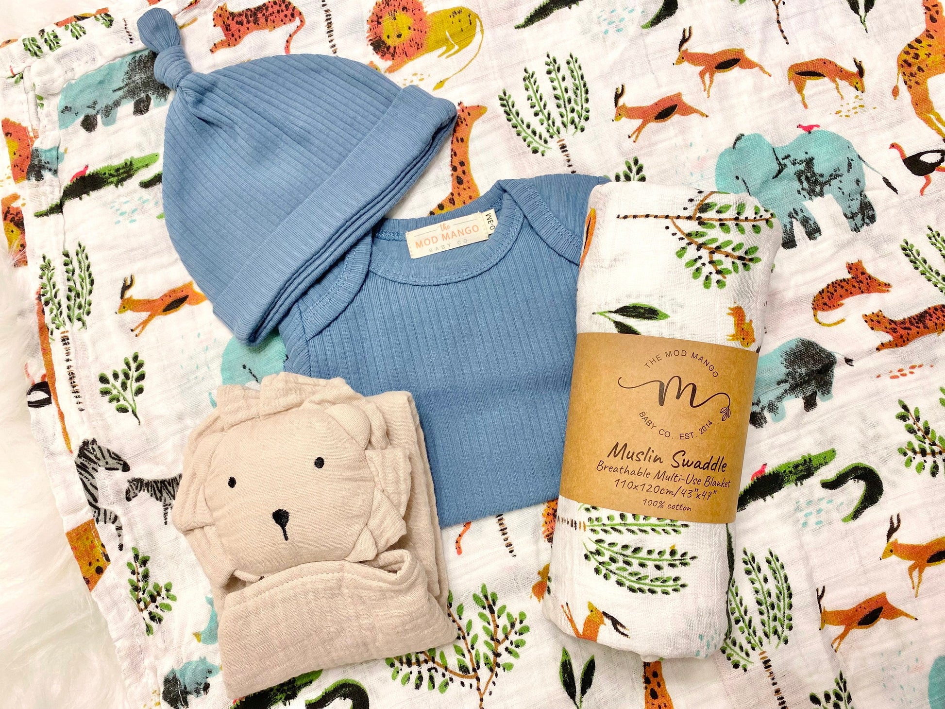 baby boy gift, newborn boy gift set, gift baby boy, jungle safari swaddle blanket, blue ribbed knit long sleeve bodysuit with knot hat, muslin swaddle organic cotton gift set baby boy, lion lovey comforter blanket, baby shower gift set box