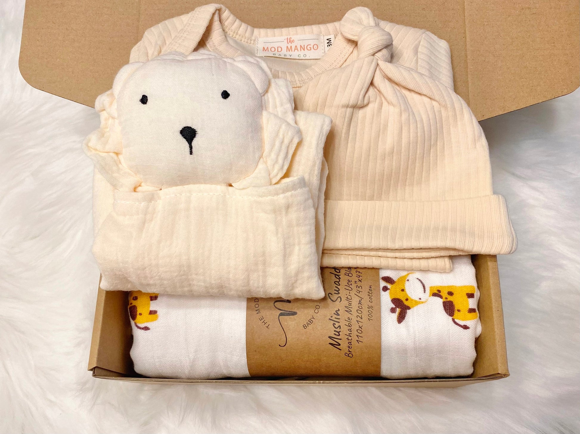 baby boy gift, newborn boy gift set, gift baby boy, giraffe swaddle blanket, neutral cream beige ivory ribbed knit long sleeve bodysuit with knot hat, muslin swaddle organic cotton gift set baby boy, lion lovey comforter blanket,