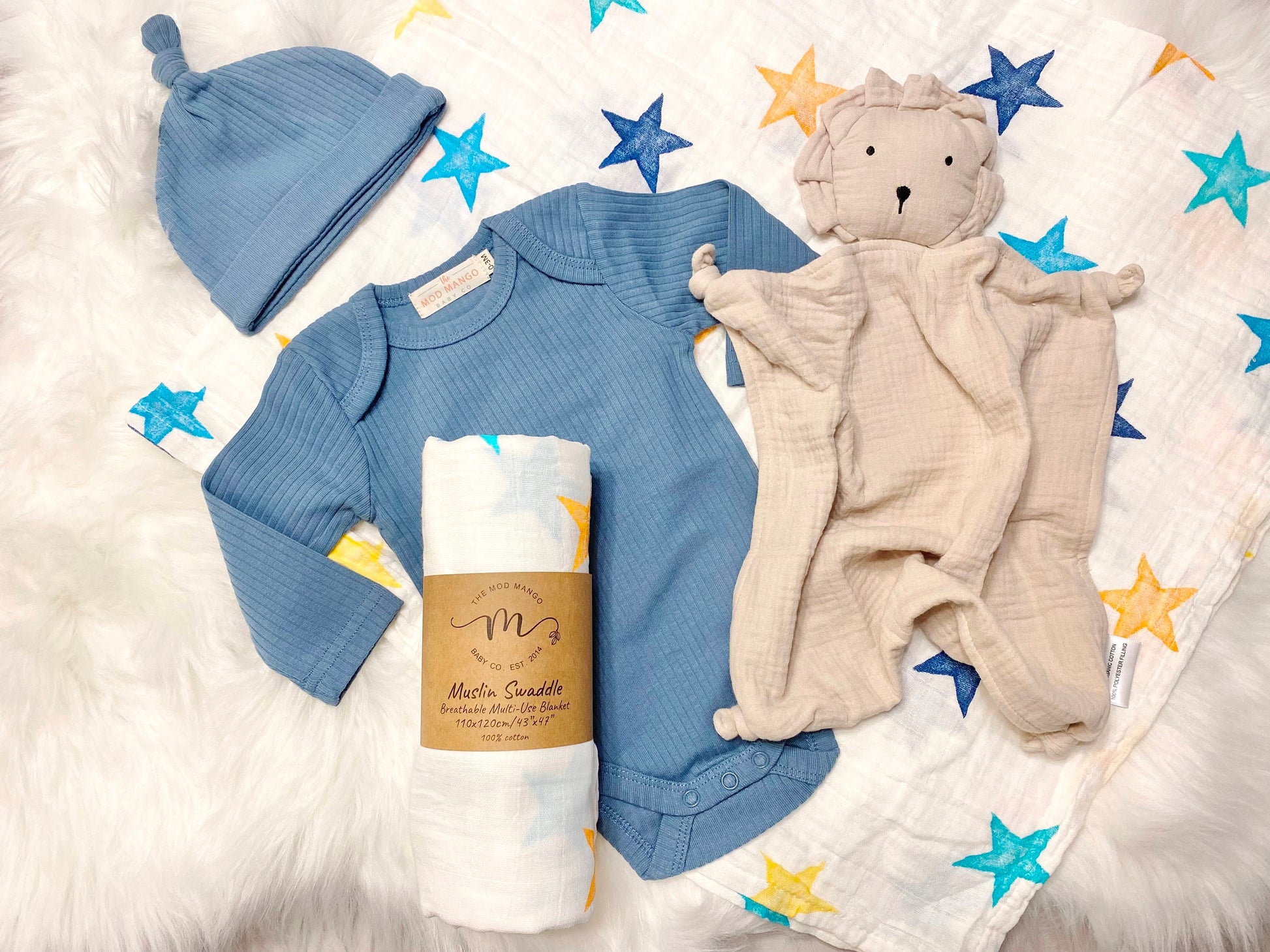 baby boy gift, newborn boy gift set, gift baby boy, stars swaddle blanket, blue ribbed knit long sleeve bodysuit with knot hat, muslin swaddle organic cotton gift set baby boy, lion lovey comforter blanket, yellow turquoise colorful baby boy gift