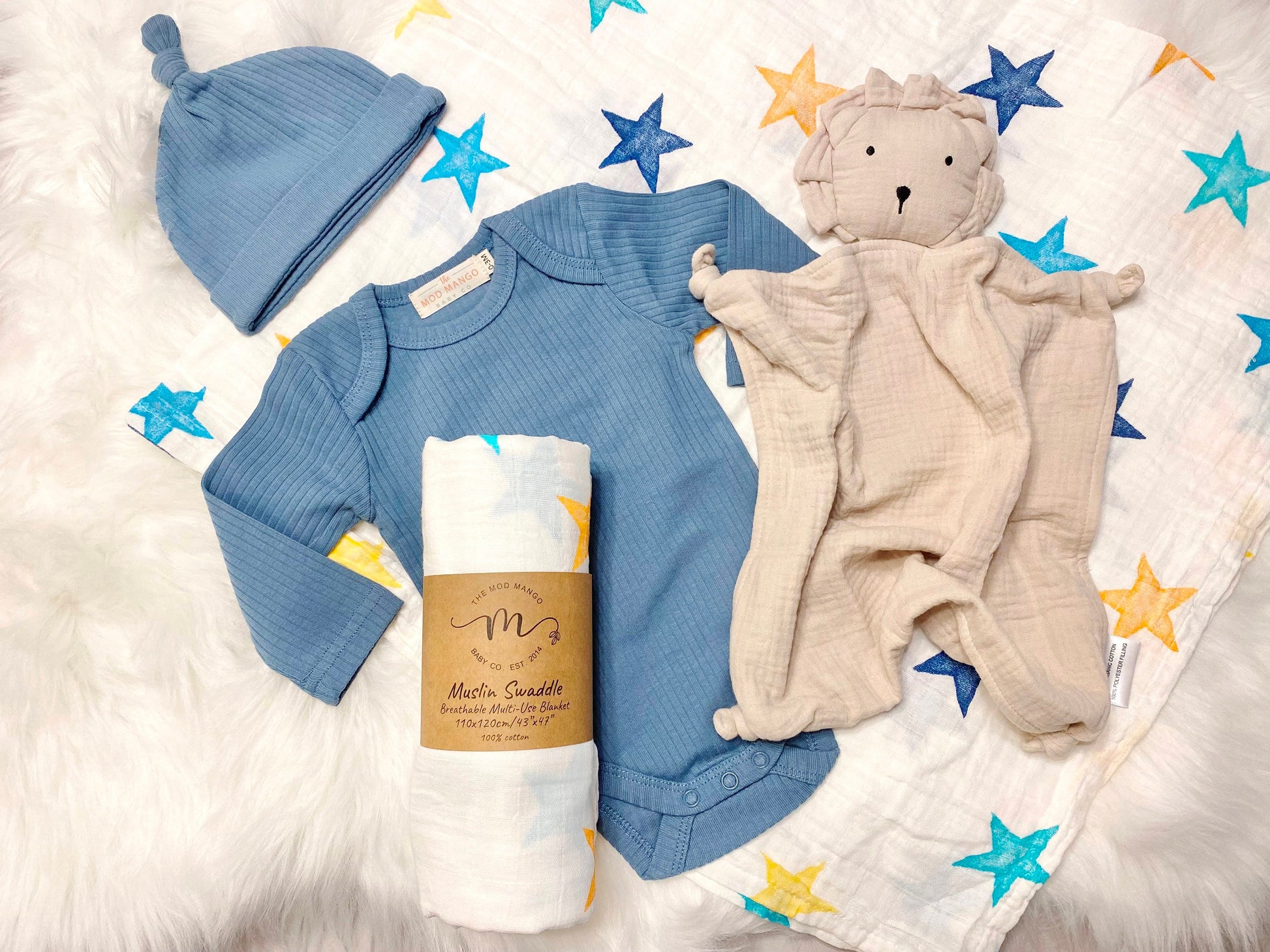 baby boy gift, newborn boy gift set, gift baby boy, stars swaddle blanket, blue ribbed knit long sleeve bodysuit with knot hat, muslin swaddle organic cotton gift set baby boy, lion lovey comforter blanket, yellow turquoise colorful baby boy gift