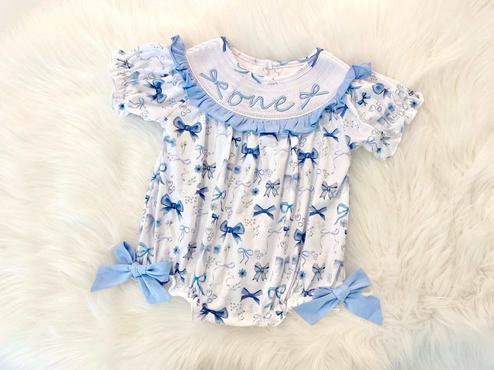 blue bow first birthday girl romper blue and white outfit navy blue blueberry, coquette love shack fancy one bubble girls just want to be one little candle smocked bubble romper first birthday winter bows ruffle bows embroidered smocked short sleeve 1st birthday outfit romper baby girls, 4th of july summer blue and white flowers floral, patriotic boy girl twins, the mod mango baby boutique co