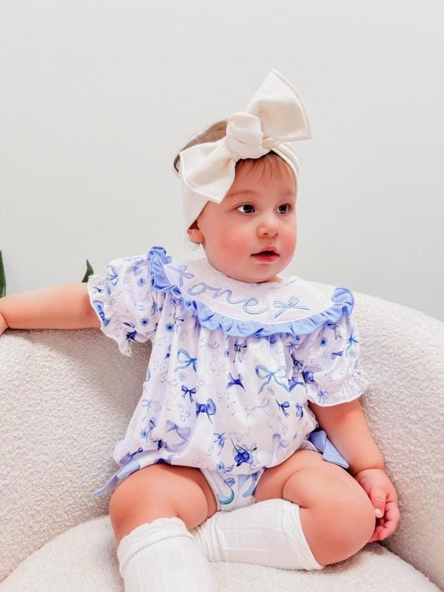 blue bow first birthday girl romper blue and white outfit, love shack fancy one bubble girls just want to be one smocked bubble romper first birthday spring bows ruffle bows  embroidered smocked short sleeve 1st birthday outfit romper baby girls