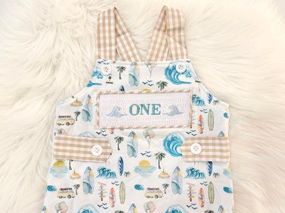 the big one first birthday boy romper my first wave summer beach surfer aqua blue tan white gingham yellow smash cake outfit overalls, ONE smocked romper first birthday beach party surfing, ocean embroidered smocked spring summer 1st birthday boy outfit romper baby boys