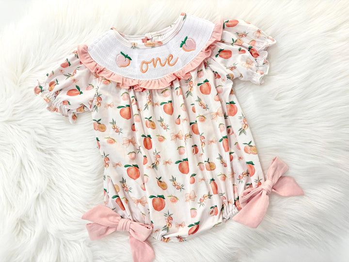 one sweet peach girls first birthday bubble romper outfit peachy blush pink bows first birthday girl romper peach and white outfit, peach smocked dress first birthday embroidered peaches smocked short sleeve 1st birthday outfit ruffle bubble romper baby girls fruit cake smash outfit