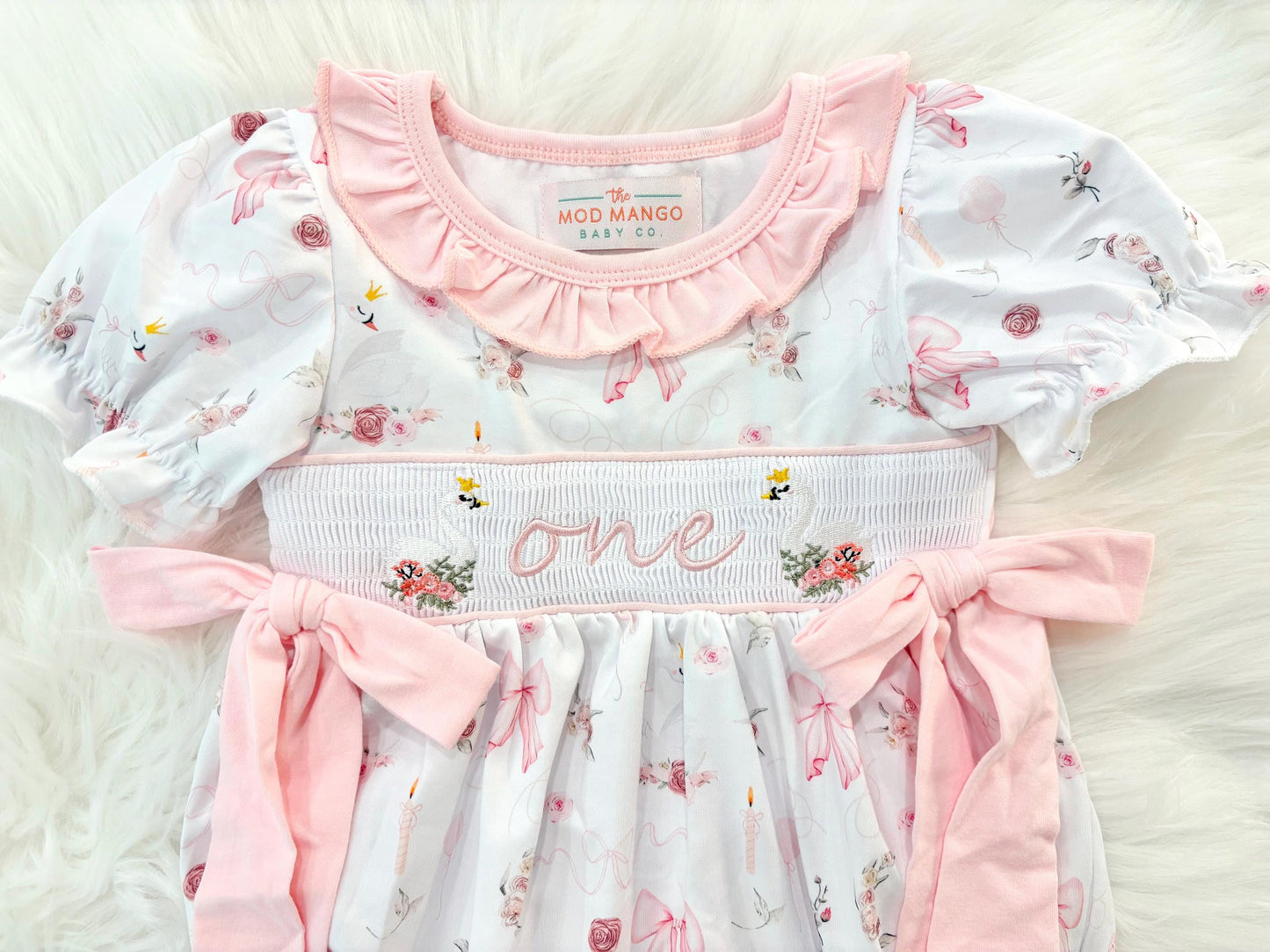swan princess first birthday outfit bubble romper pink and white floral flowers and bows first birthday girl romper pink and white outfit, girls swans sweet white smocked bubble romper first birthday spring summer bows ruffle embroidered smocked swan 1st birthday outfit romper baby girl cake smash outfit, the mod mango baby boutique co