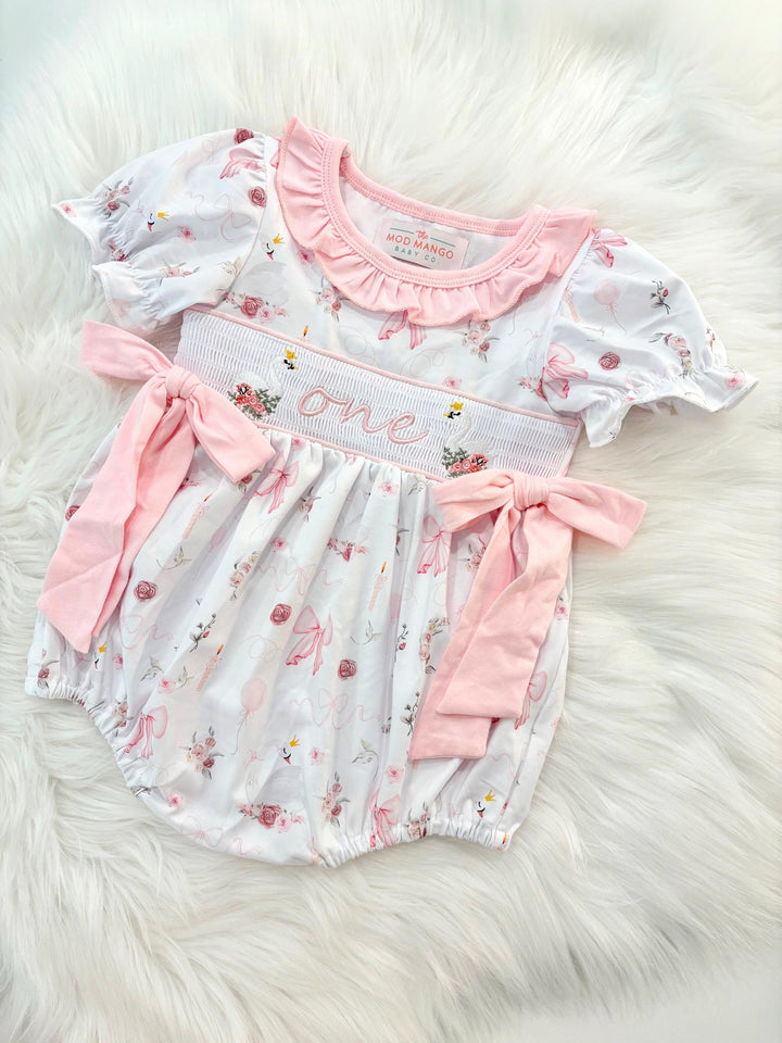 swan princess first birthday outfit bubble romper pink and white floral flowers and bows first birthday girl romper pink and white outfit, girls swans sweet white smocked bubble romper first birthday spring summer bows ruffle embroidered smocked swan 1st birthday outfit romper baby girl cake smash outfit, the mod mango baby boutique co