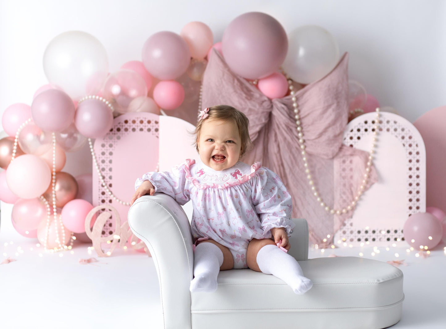 pink bow first birthday girl romper pink and white outfit, pink white smocked bubble romper first birthday winter bows ruffle bows  embroidered smocked long sleeve 1st birthday outfit romper baby girls the mod mango baby boutique