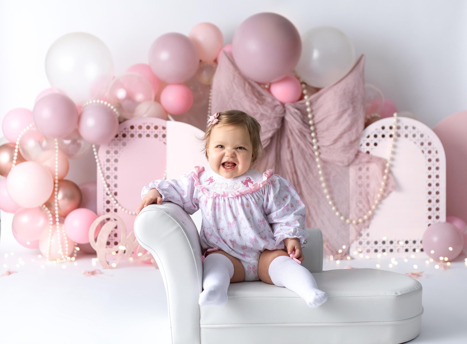 pink bow first birthday girl romper pink and white outfit, pink white smocked bubble romper first birthday winter bows ruffle bows  embroidered smocked long sleeve 1st birthday outfit romper baby girls the mod mango baby boutique