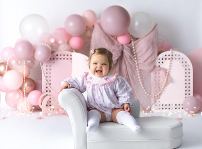 pink bow first birthday girl romper pink and white outfit, pink white smocked bubble romper first birthday winter bows ruffle bows  embroidered smocked long sleeve 1st birthday outfit romper baby girls the mod mango baby boutique