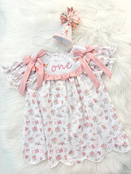 wild one wildflower ONEderful girls first birthday dress outfit blush pink flowers and bows first birthday girl dress pink and white outfit, one little candle, dusty rose blush pink green floral smocked dress first birthday embroidered flowers smocked short sleeve 1st birthday outfit ruffle scalloped dress, the mod mango baby boutique co
