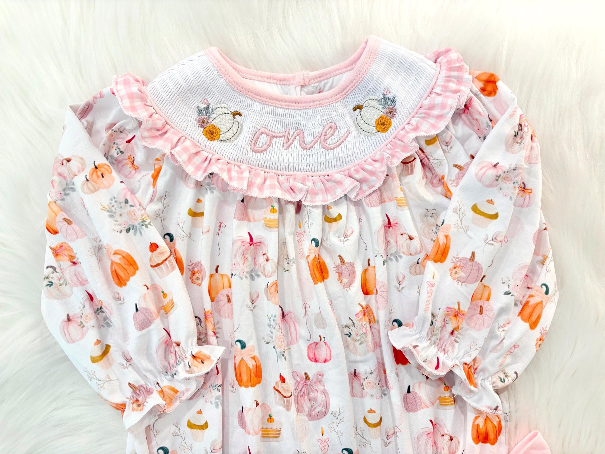 pink pumpkin bow first birthday girl romper blush pink orange floral and white outfit, pink and white gingham smocked bubble romper first birthday fall pumpkins ruffle bows embroidered smocked long sleeve 1st birthday outfit romper baby girls, the mod mango, the mod mango baby co baby boutique