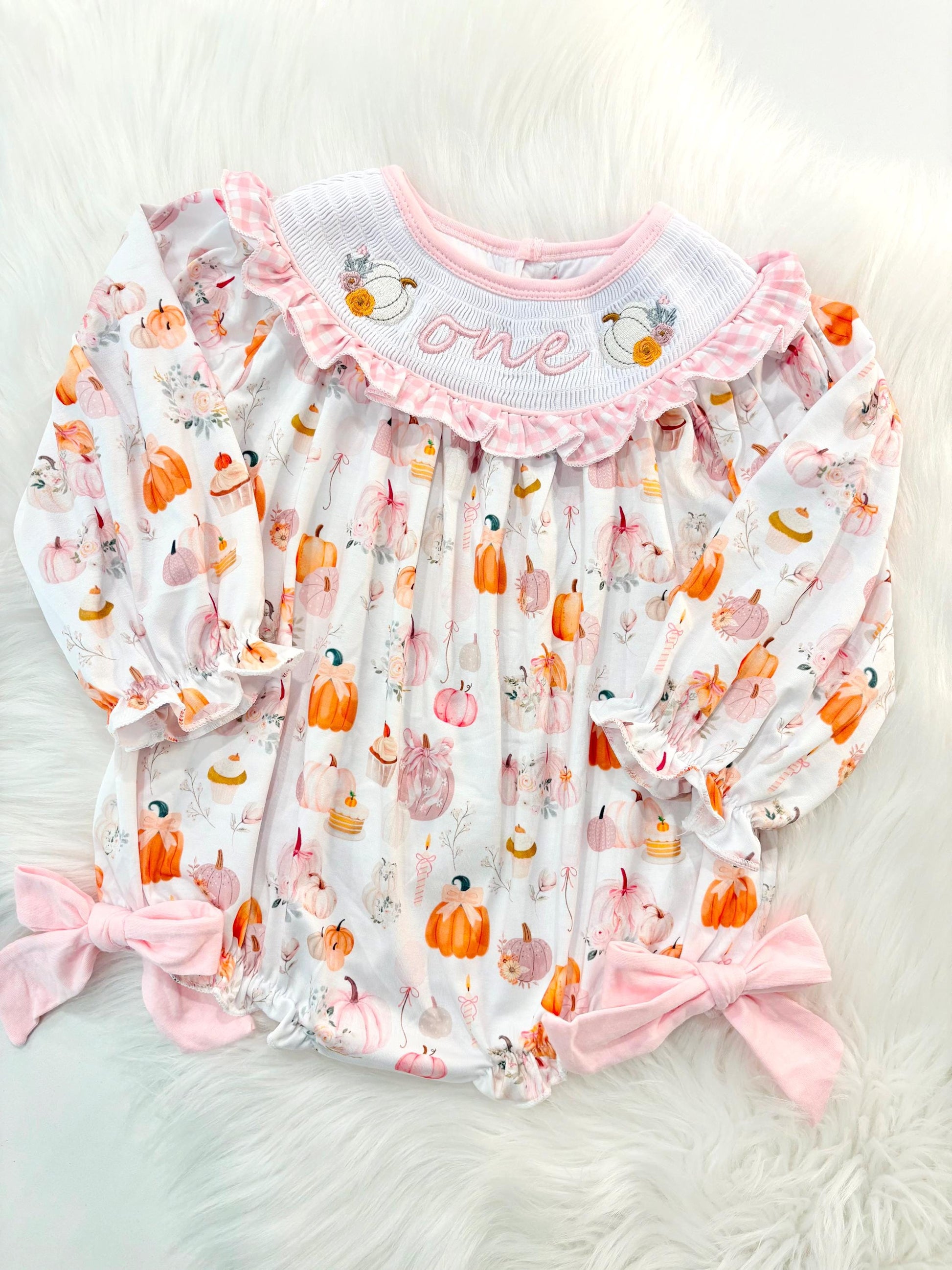 pink pumpkin bow first birthday girl romper blush pink orange floral and white outfit, pink and white gingham smocked bubble romper first birthday fall pumpkins ruffle bows embroidered smocked long sleeve 1st birthday outfit romper baby girls, the mod mango, the mod mango baby co baby boutique