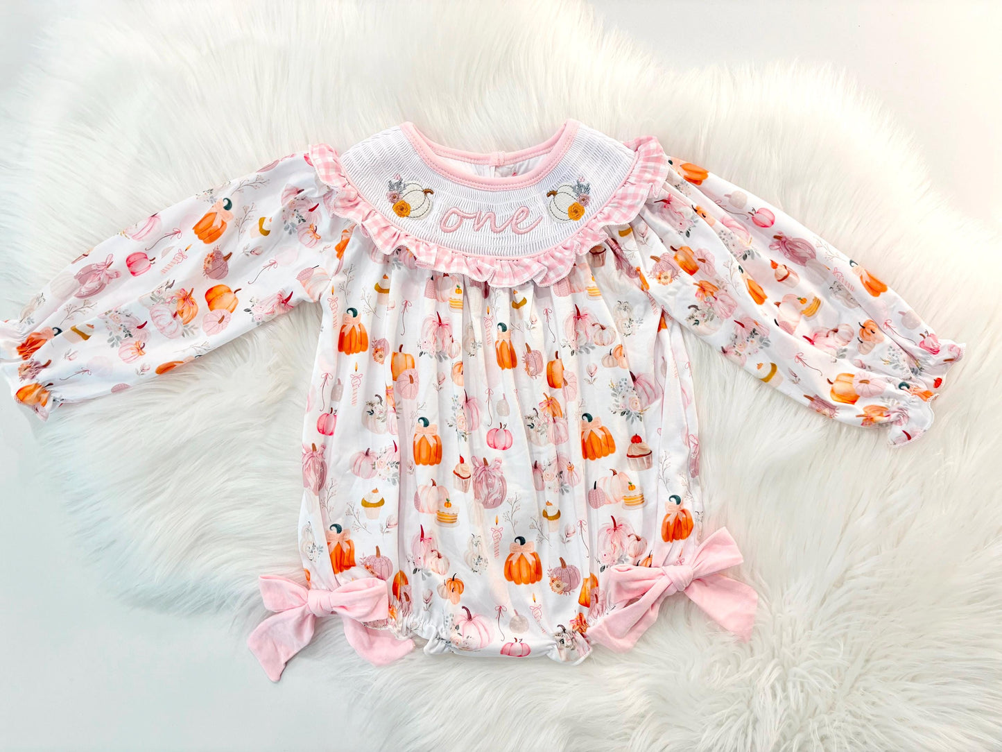 pink pumpkin bow first birthday girl romper blush pink orange floral and white outfit, pink and white gingham smocked bubble romper first birthday fall pumpkins ruffle bows embroidered smocked long sleeve 1st birthday outfit romper baby girls, the mod mango, the mod mango baby co baby boutique