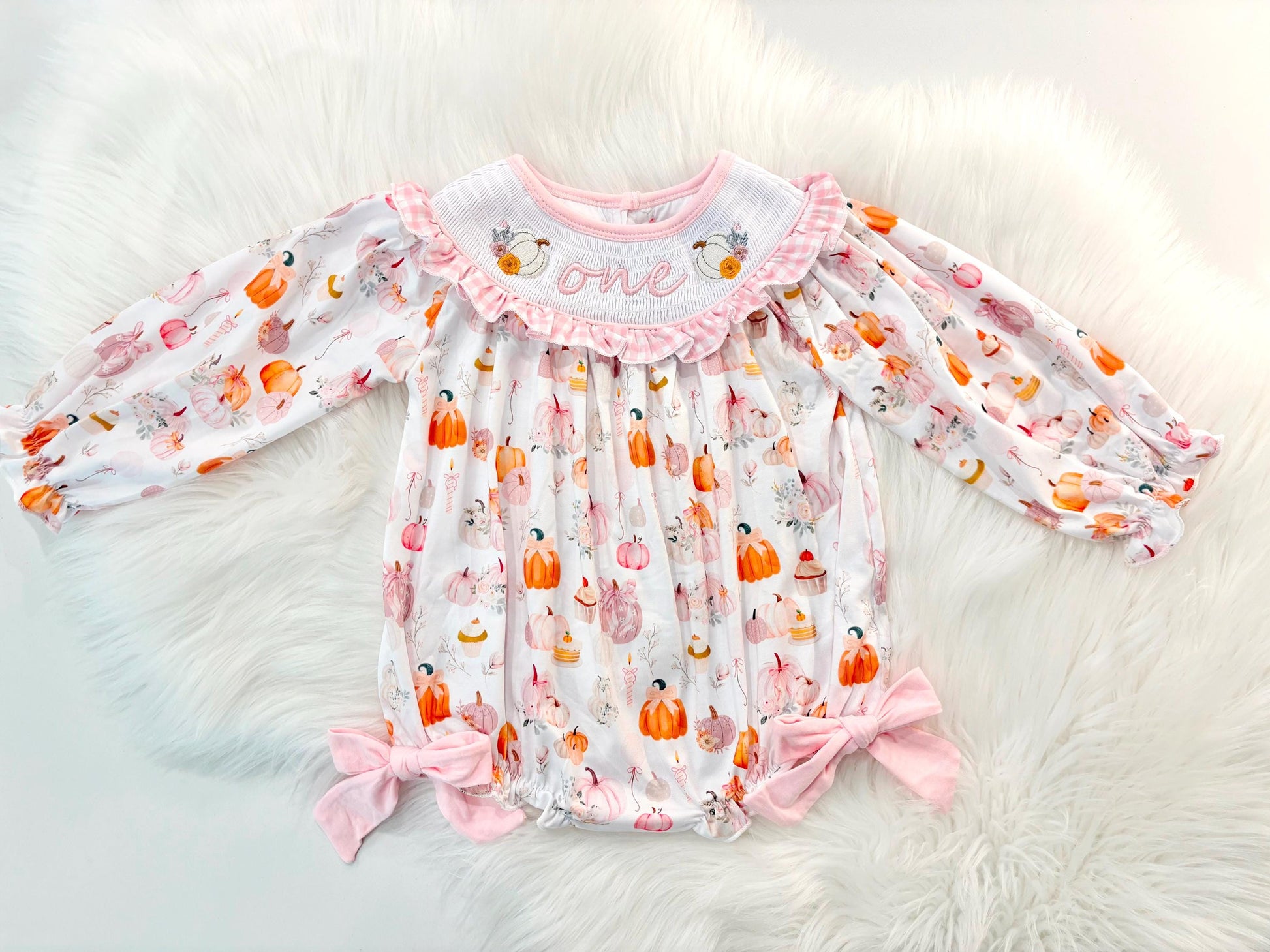 pink pumpkin bow first birthday girl romper blush pink orange floral and white outfit, pink and white gingham smocked bubble romper first birthday fall pumpkins ruffle bows embroidered smocked long sleeve 1st birthday outfit romper baby girls, the mod mango, the mod mango baby co baby boutique