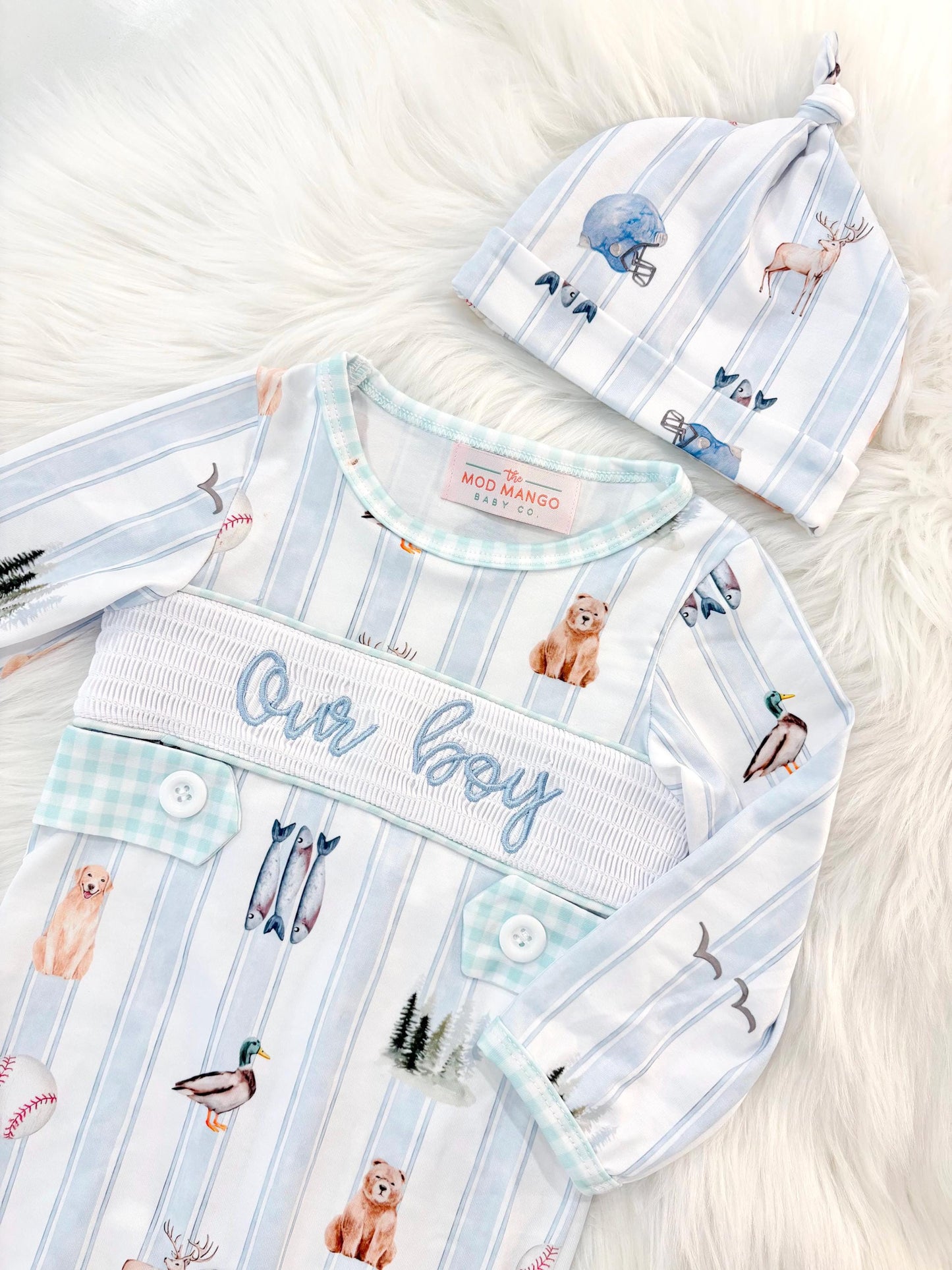newborn boys baby blue and white smocked baby romper outfit bodysuit and knotted hat with stripes and boy hunting for baby, fish buck deer bear football sports baseball mallard duck puppy dog pine trees outdoor all american boy, our boy monogram baby shower gift for boy, light blue and mint green gingham baby gift, newborn coming home outfit, baby shower gift set, pregnancy announcement, custom newborn baby romper outfit, boutique smocked baby gift set, the mod mango baby boutique co