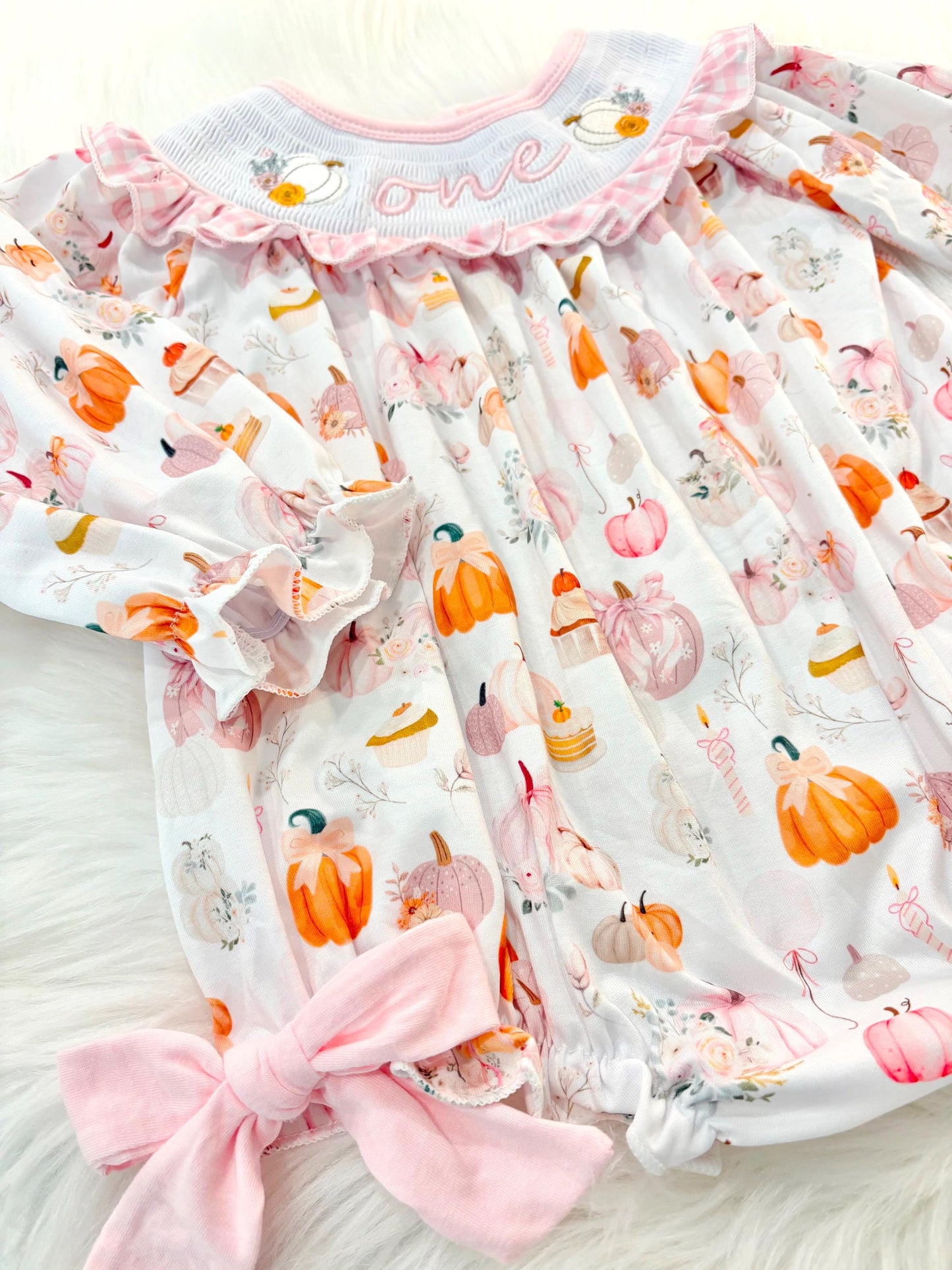 pink pumpkin bow first birthday girl romper blush pink orange floral and white outfit, pink and white gingham smocked bubble romper first birthday fall pumpkins ruffle bows embroidered smocked long sleeve 1st birthday outfit romper baby girls, the mod mango, the mod mango baby co baby boutique