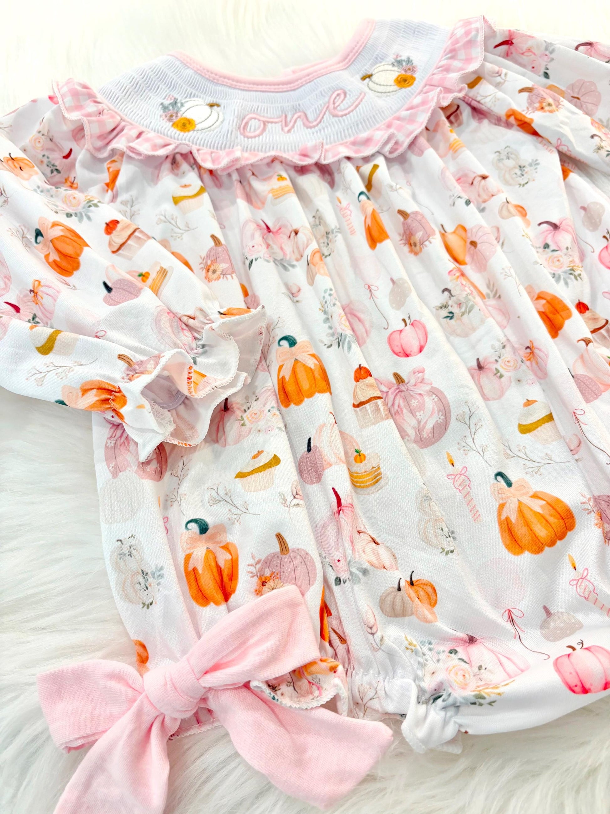 pink pumpkin bow first birthday girl romper blush pink orange floral and white outfit, pink and white gingham smocked bubble romper first birthday fall pumpkins ruffle bows embroidered smocked long sleeve 1st birthday outfit romper baby girls, the mod mango, the mod mango baby co baby boutique