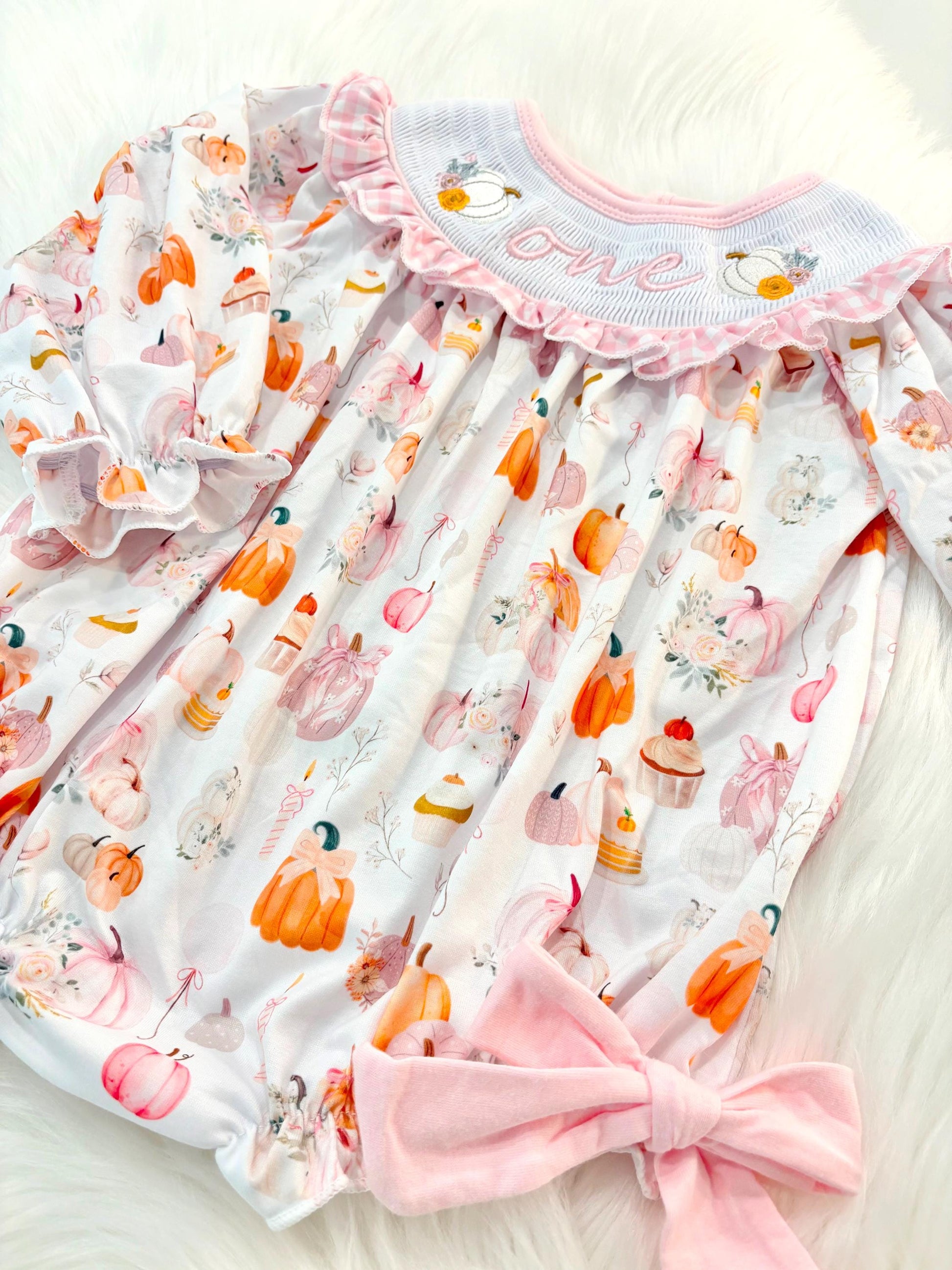 pink pumpkin bow first birthday girl romper blush pink orange floral and white outfit, pink and white gingham smocked bubble romper first birthday fall pumpkins ruffle bows embroidered smocked long sleeve 1st birthday outfit romper baby girls, the mod mango, the mod mango baby co baby boutique