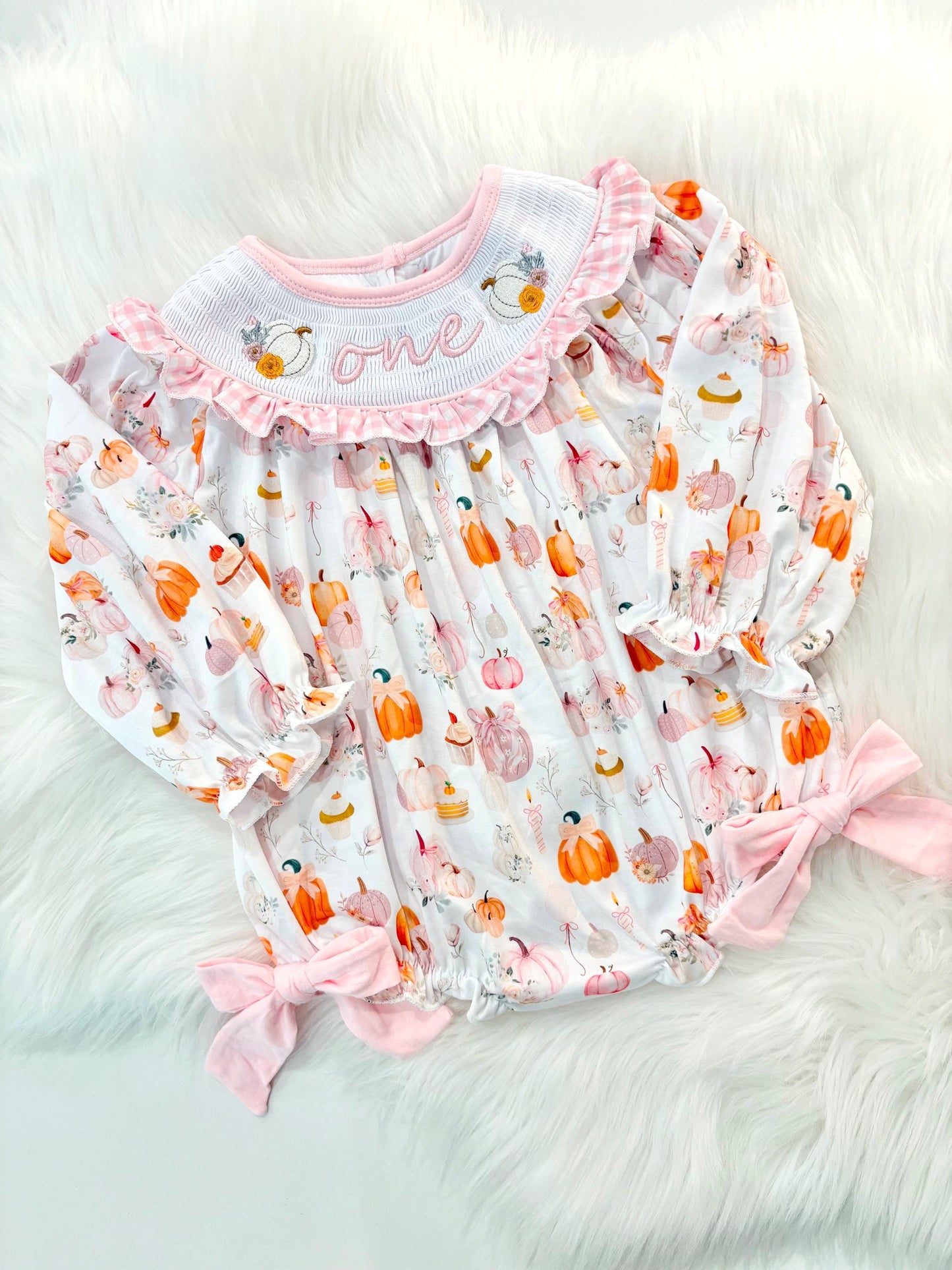 pink pumpkin bow first birthday girl romper blush pink orange floral and white outfit, pink and white gingham smocked bubble romper first birthday fall pumpkins ruffle bows embroidered smocked long sleeve 1st birthday outfit romper baby girls, the mod mango, the mod mango baby co baby boutique