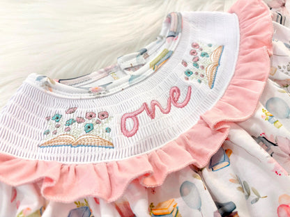 pink books flowers bows first birthday girl romper blush pink blue pastel floral and white outfit, pink and white smocked bubble romper first birthday chapter one books ruffle bows embroidered smocked long sleeve 1st birthday outfit romper baby girls, the mod mango, the mod mango baby co baby boutique