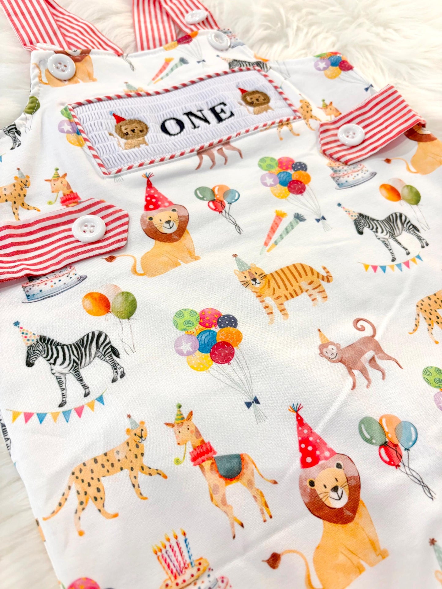 carnival circus party animal cake smash outfit first birthday boy romper 1st birthday red  and white striped stripes colorful smash cake outfit overalls, ONE smocked romper first birthday, animals lion embroidered smocked spring summer 1st birthday boy outfit romper baby boys cake smash outfit, the mod mango baby boutique co