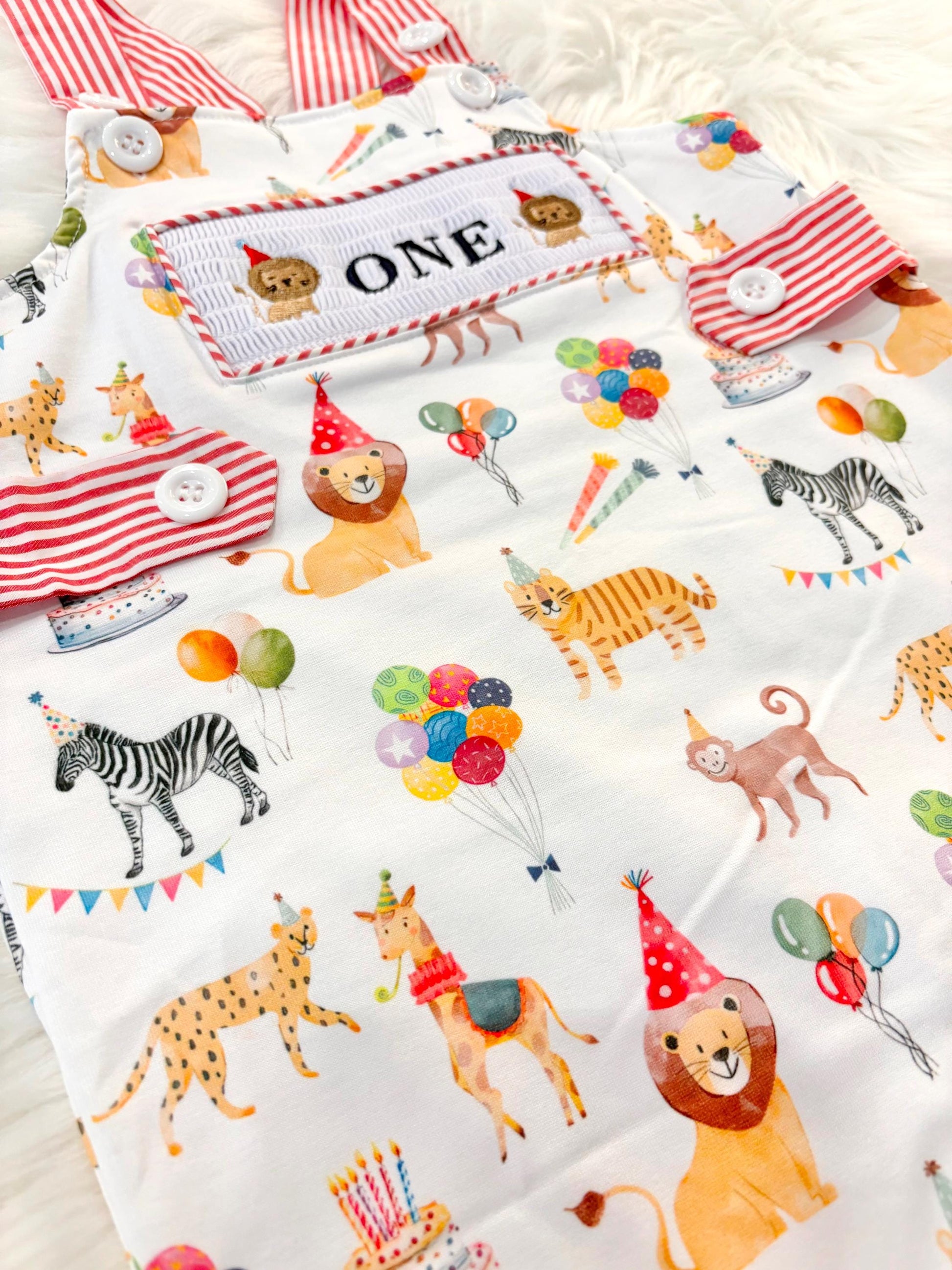 carnival circus party animal cake smash outfit first birthday boy romper 1st birthday red  and white striped stripes colorful smash cake outfit overalls, ONE smocked romper first birthday, animals lion embroidered smocked spring summer 1st birthday boy outfit romper baby boys cake smash outfit, the mod mango baby boutique co