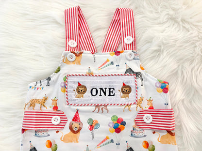 carnival circus party animal cake smash outfit first birthday boy romper 1st birthday red  and white striped stripes colorful smash cake outfit overalls, ONE smocked romper first birthday, animals lion embroidered smocked spring summer 1st birthday boy outfit romper baby boys cake smash outfit, the mod mango baby boutique co